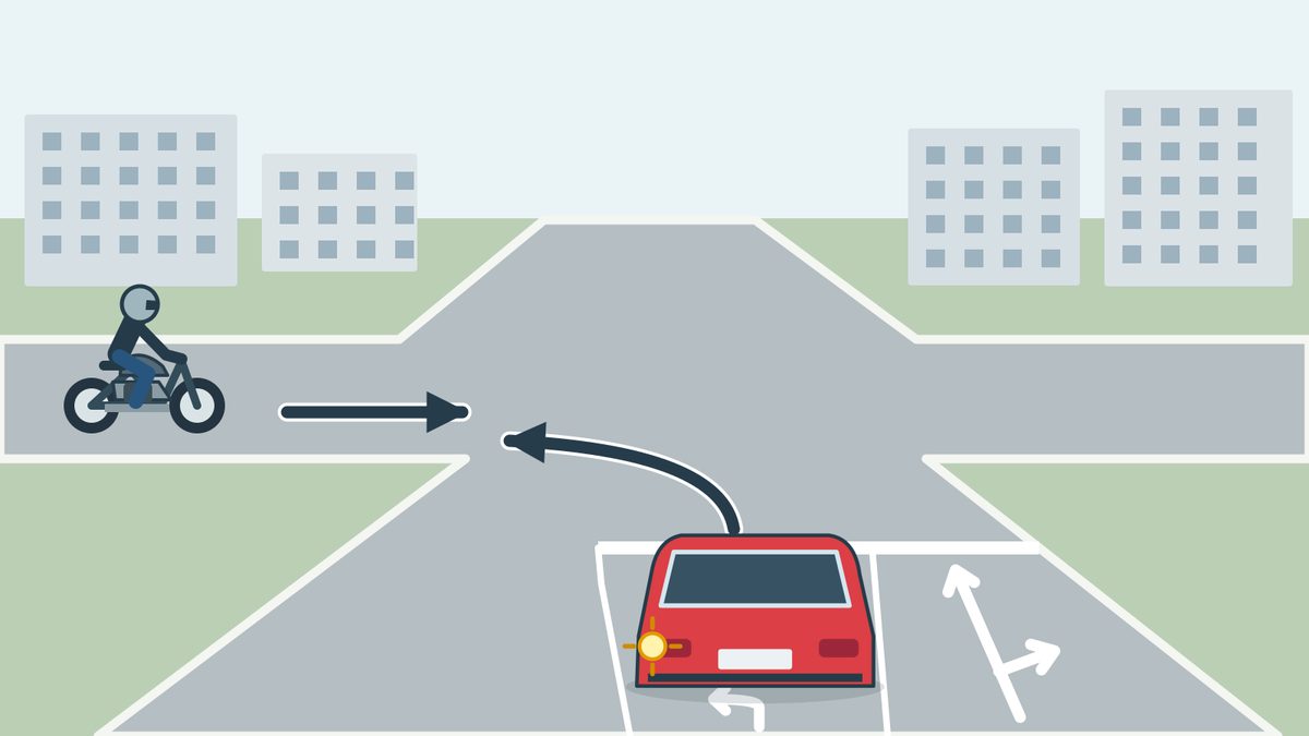 An urban unsigned junction: a red car indicates left from a left-turn lane; a motorcyclist approaches from the left going straight. The adjacent lane has straight and right arrows. A white transverse approach line extends beside the red car across the adjacent lane.