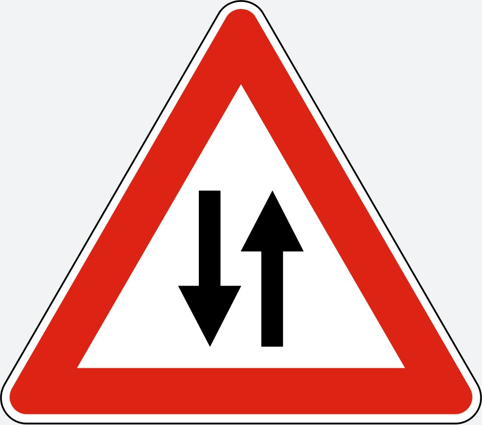 Upright white triangle with a red border; two parallel black arrows, the left pointing down and the right pointing up.