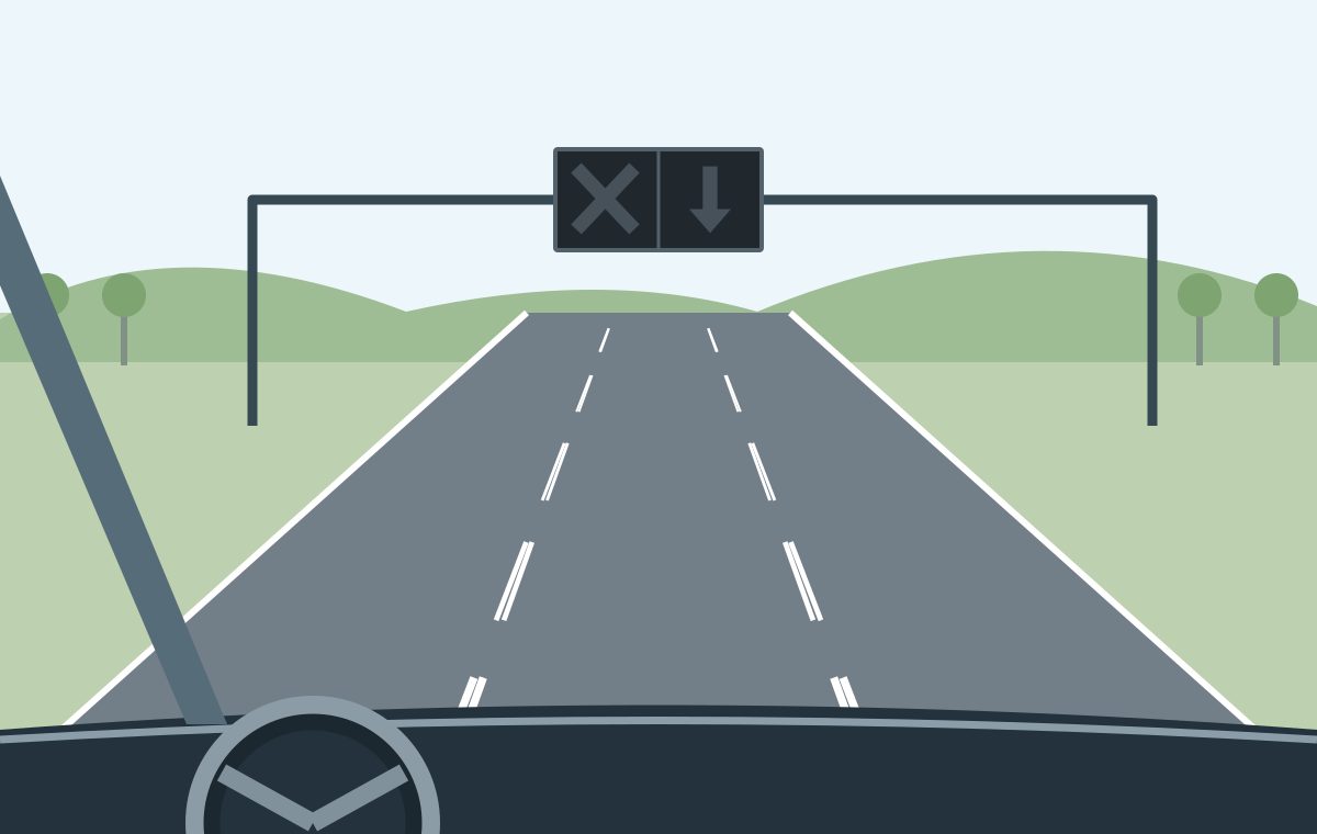 Driver view of a rural road with an unlit lane-control signal above the middle lane.