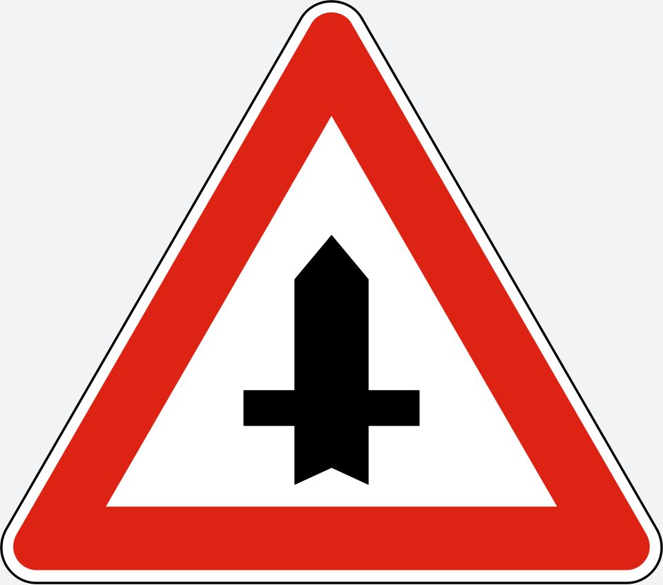 Red-bordered upright triangle; thick upright arrow-topped stem crossed by a thin horizontal bar.