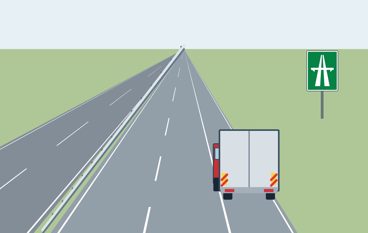 A lorry in the emergency lane beside an otherwise empty motorway.