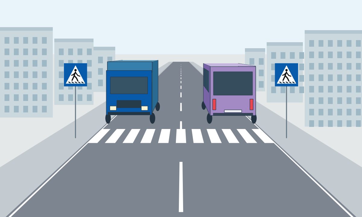 A lorry and a bus beside a zebra crossing, facing opposite directions.