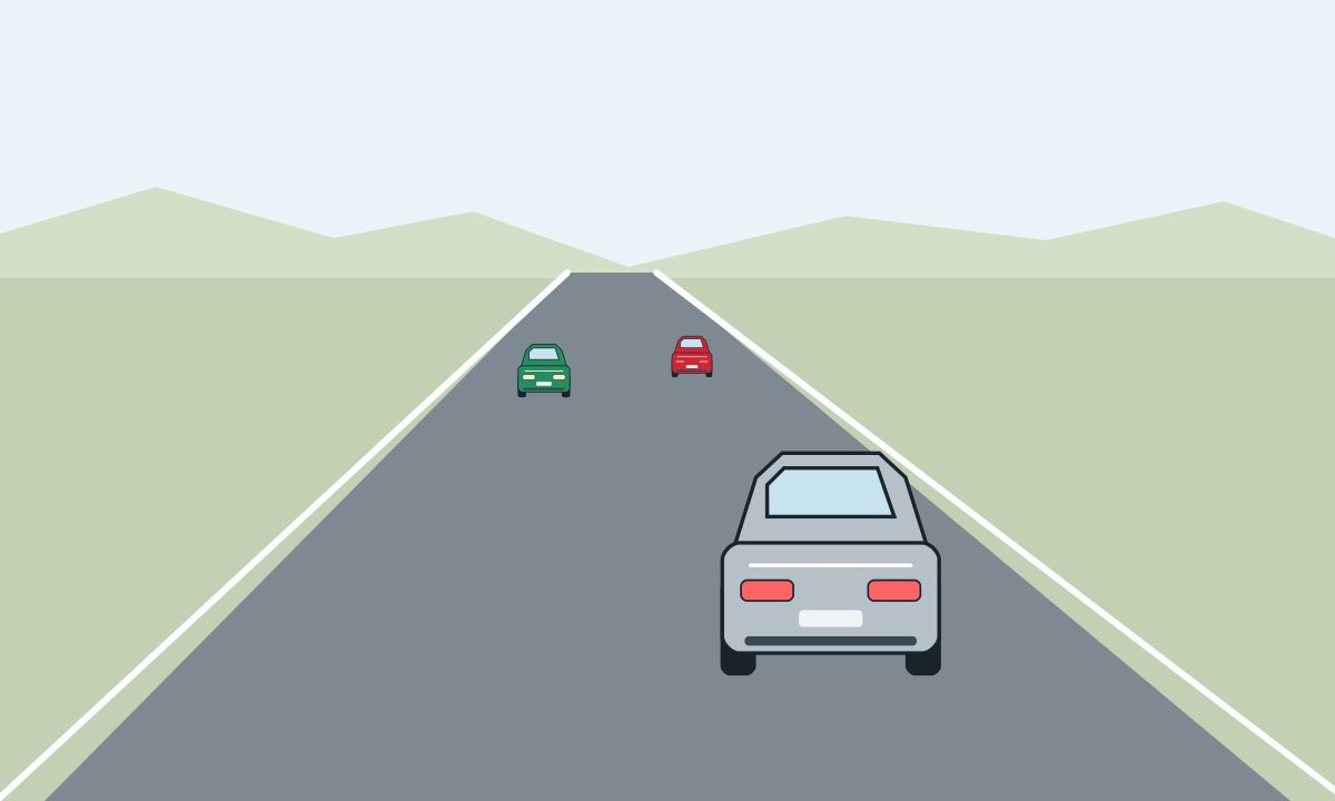 A silver car ahead on an unmarked two-way road, with a red car farther ahead and a green car facing the viewer on the left.