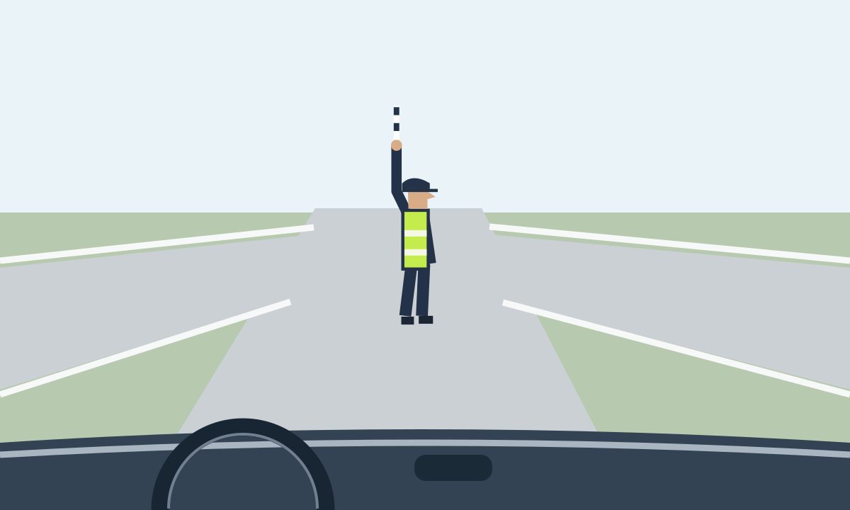 View through a windscreen towards a controller in profile facing right, with one arm and striped baton raised vertically and the other arm lowered.