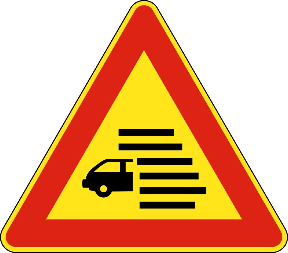 Red-bordered triangle with a car and horizontal lines.