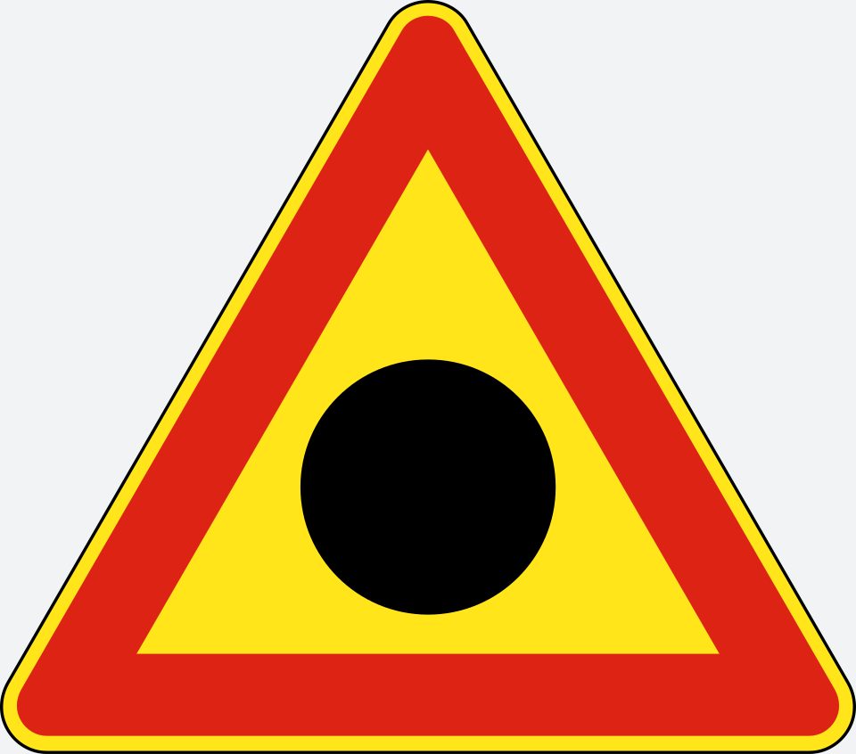 Red-bordered upright triangle with a yellow interior and a large black disc.