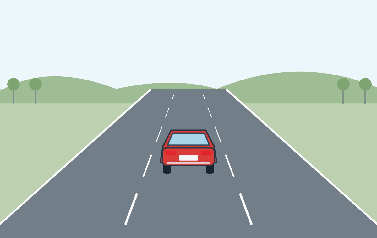 Rear view of a red car in the middle lane of a rural three-lane road, between two broken lane dividers.