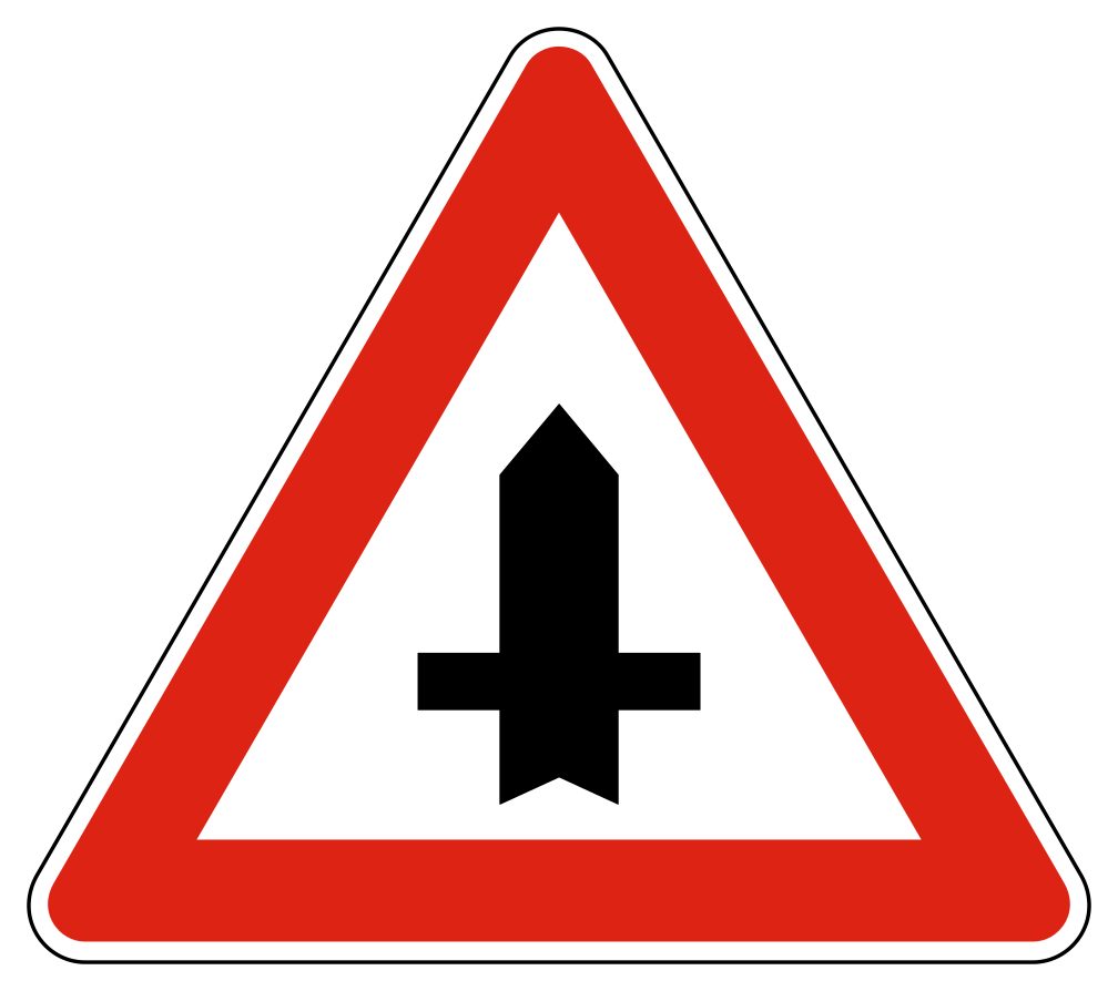 Red-bordered upright triangle containing a thick black vertical stem with narrow branches on both sides.