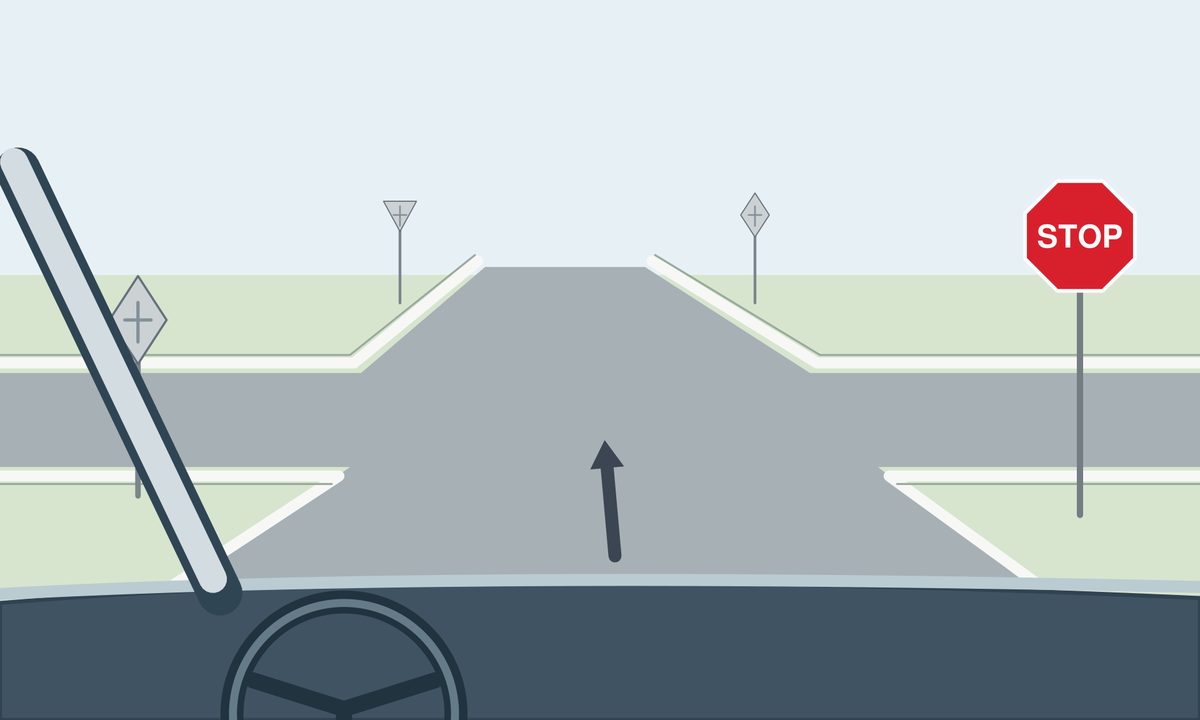 View through a windscreen toward an empty unmarked four-arm junction. A forward arrow is ahead, and a red octagonal STOP sign faces the viewer on the right.