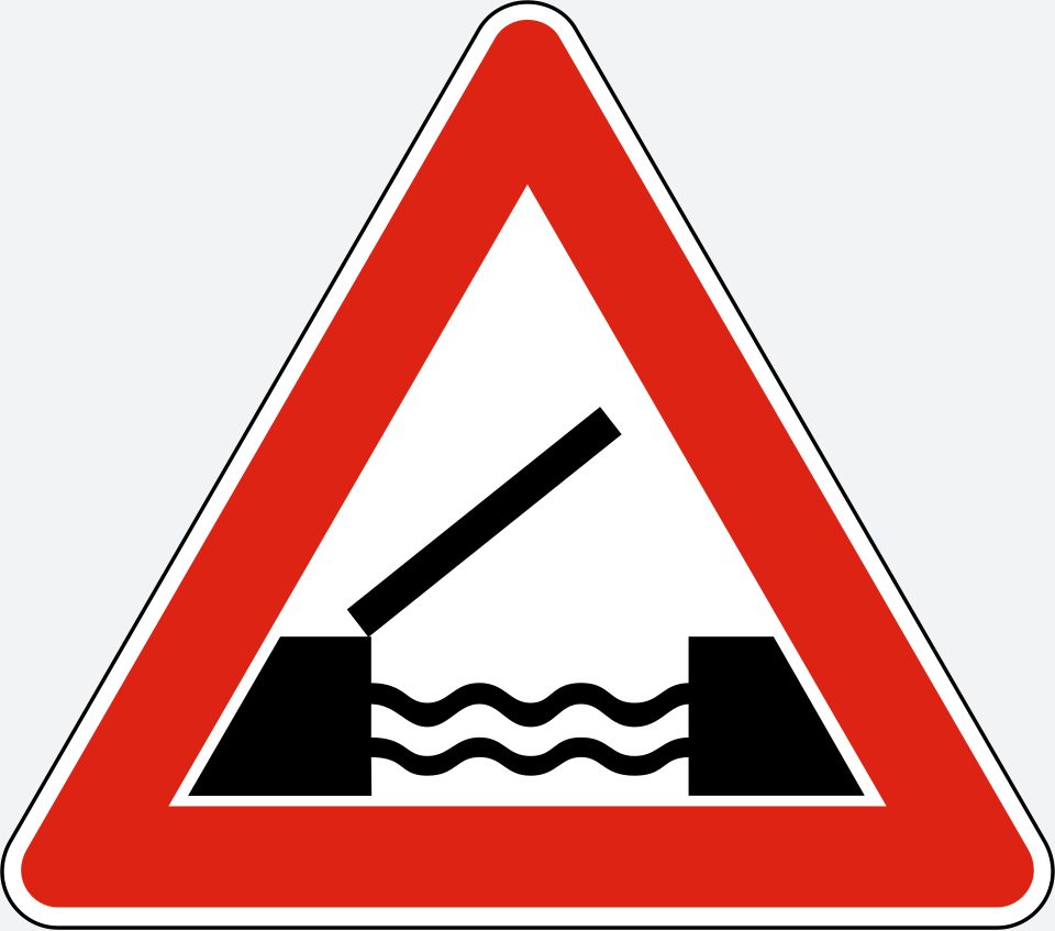 Upright white triangle with a red border; a black bridge deck rises diagonally to the right above wavy water lines between two banks.