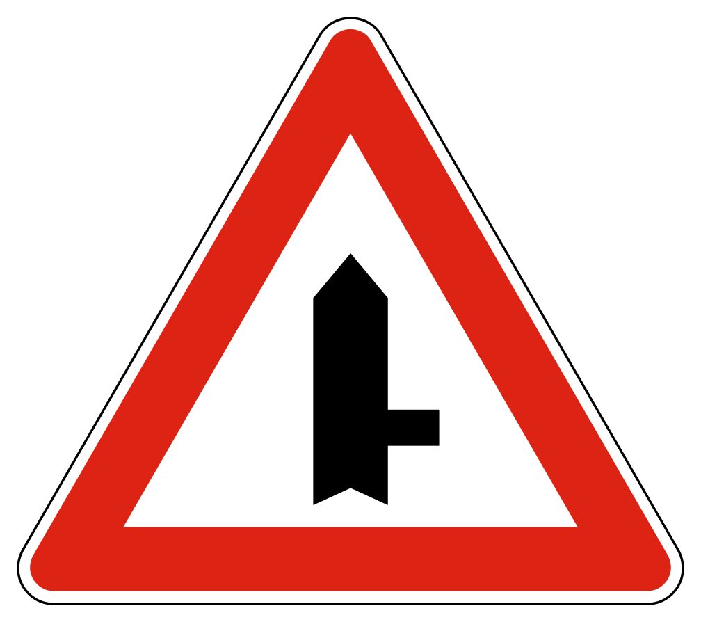 Red-bordered upright triangle containing a thick black vertical stem with one narrow branch to the right.