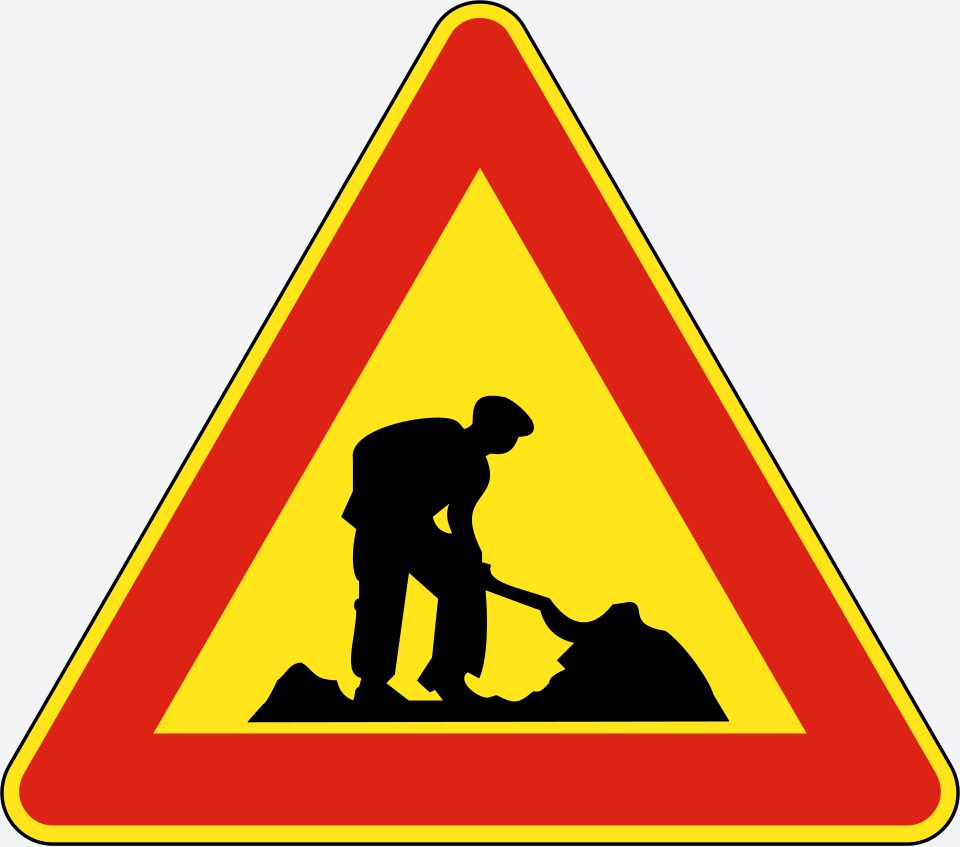 Red-bordered upright triangle with yellow interior; black person digging beside a mound.