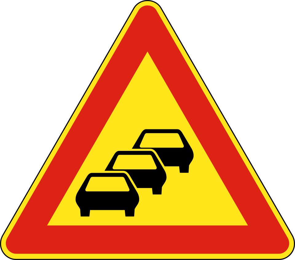 Red-bordered triangle containing three car silhouettes.